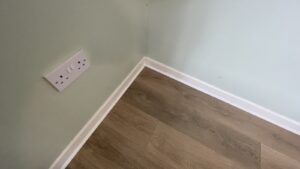 White scotia moulding installed around laminate flooring in Carlow and Borris