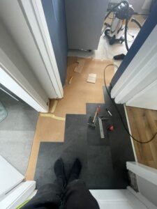 Laying luxury vinyl tile flooring in a kitchen in Carlow