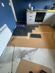 Professional vinyl flooring installation around kitchen cabinets in Carlow